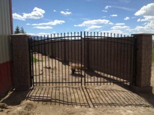 Sweeping arc metal entryway gate installed by Waters & Son Construction